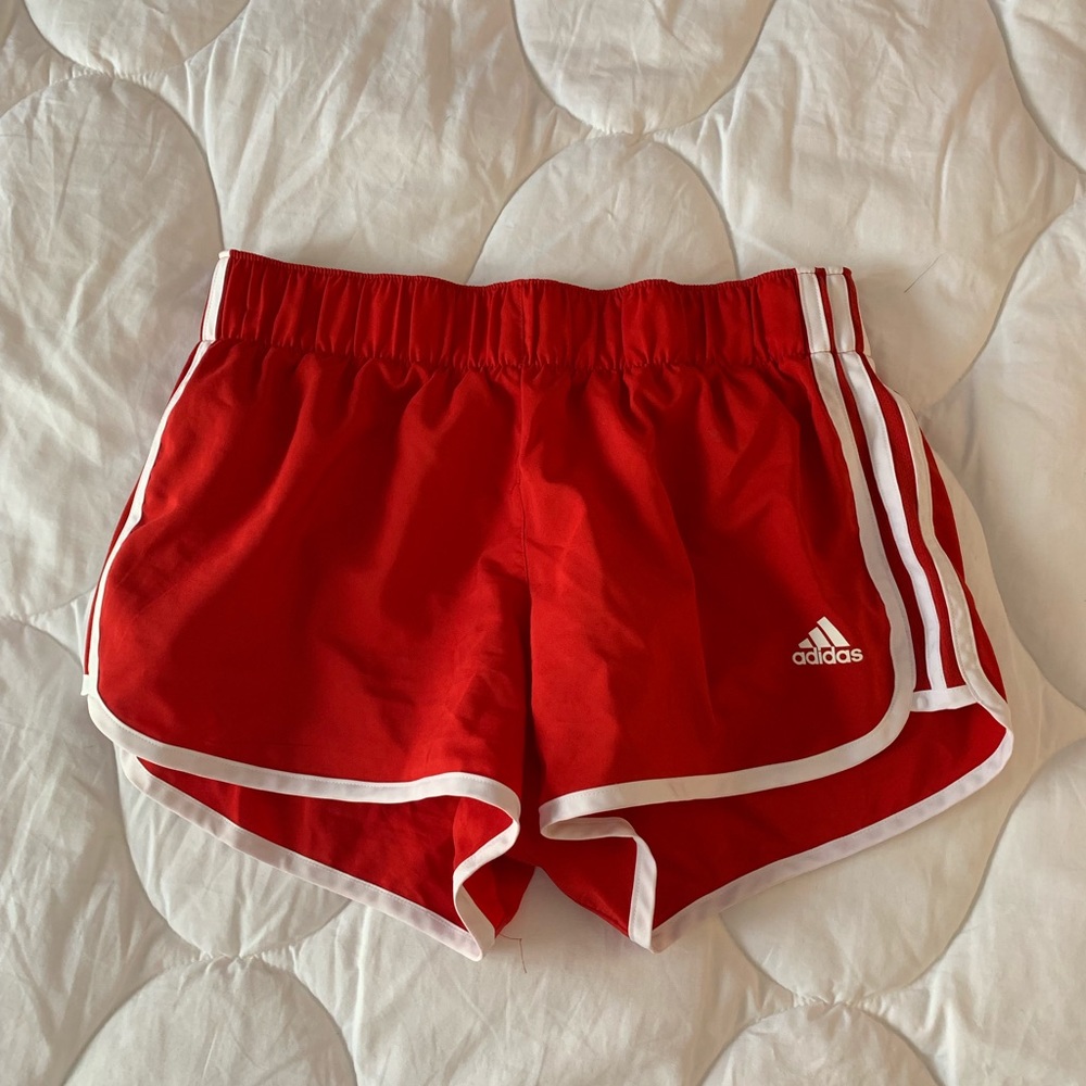 Red adidas running shorts